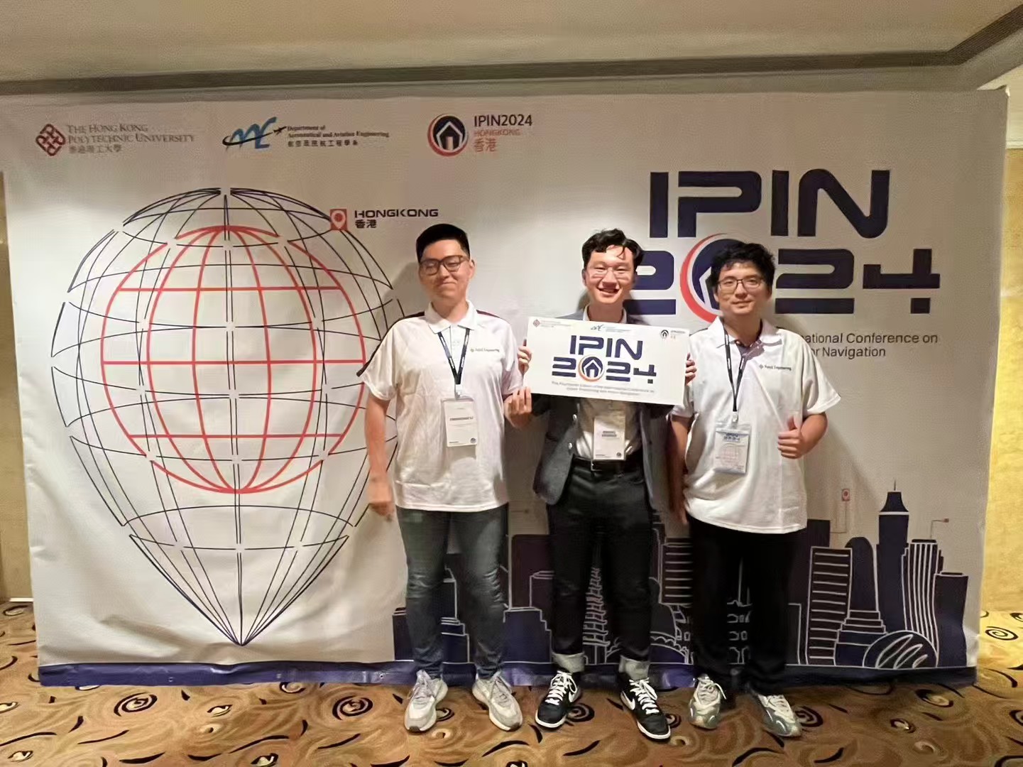 Photo with fellow participants at the IPIN 2024 backdrop